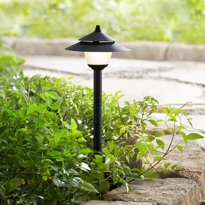 Low voltage landscape lighting illuminating a home at night